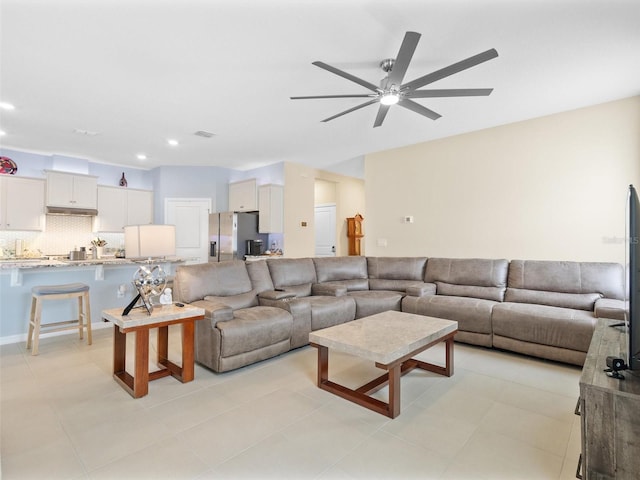 living room featuring recessed lighting, ceiling fan, and visible vents