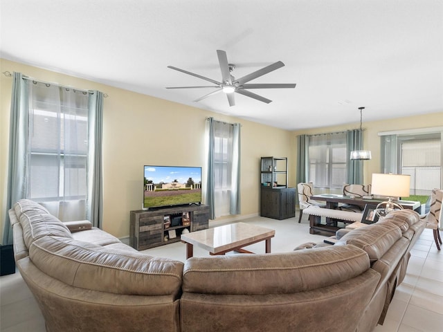 living room featuring light tile patterned floors and ceiling fan