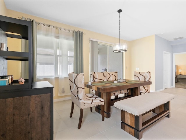 dining room featuring baseboards, visible vents, and light tile patterned floors