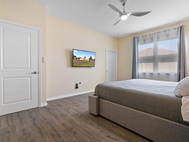 bedroom with baseboards, wood finished floors, and ceiling fan