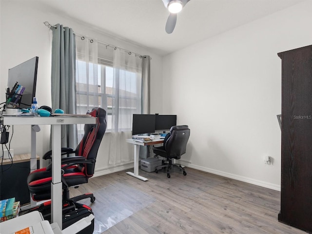 home office featuring wood finished floors, a ceiling fan, and baseboards