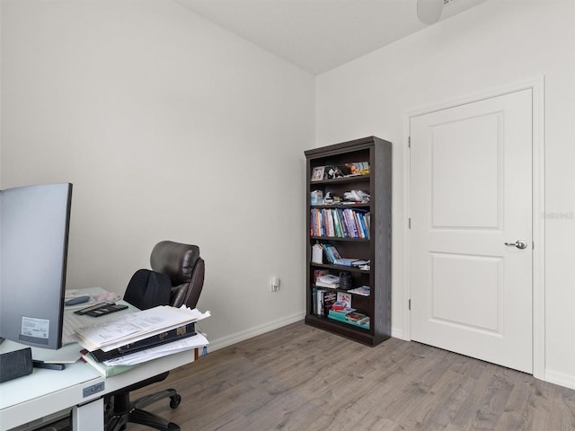home office featuring wood finished floors and baseboards