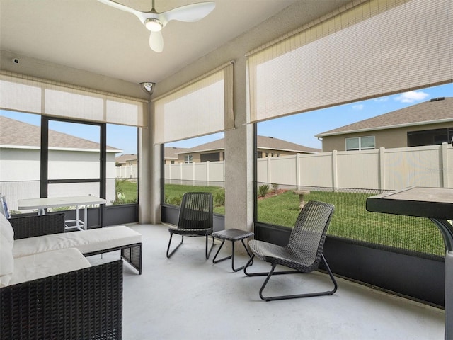 sunroom featuring a ceiling fan