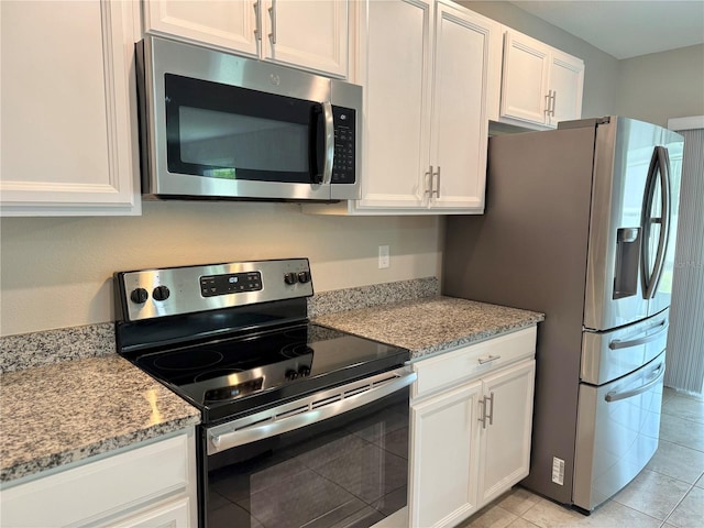 3638 SW 127th Lane Rd, Ocala, FL 34473 - kitchen with white cabinets, stainless steel appliances, and light stone countertops
