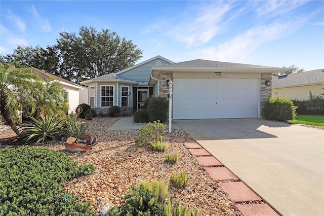 4848 Saint Andrews Arc, Leesburg, FL 34748 - ranch-style home featuring a garage, concrete driveway, and stone siding