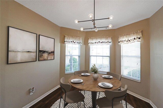 4848 Saint Andrews Arc, Leesburg, FL 34748 - dining space featuring baseboards, a chandelier, and dark wood-style floors