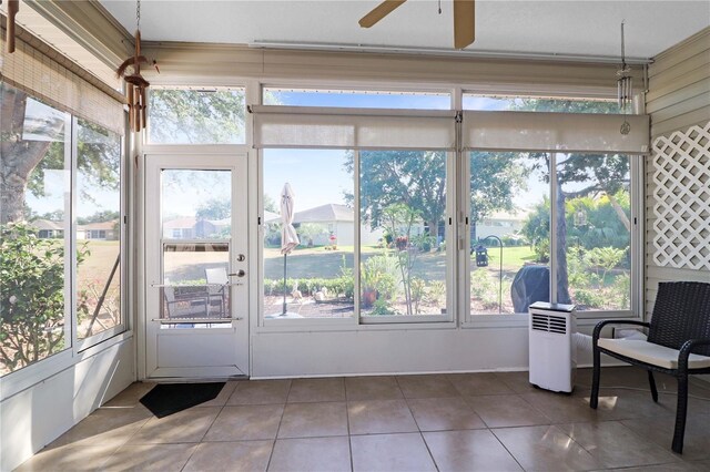 4848 Saint Andrews Arc, Leesburg, FL 34748 - sunroom with tile patterned flooring and ceiling fan