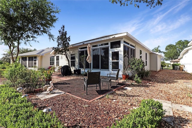 4848 Saint Andrews Arc, Leesburg, FL 34748 - back of house featuring a sunroom and a patio