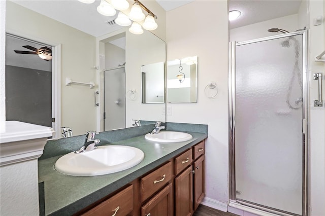 4848 Saint Andrews Arc, Leesburg, FL 34748 - bathroom with a stall shower, double vanity, a sink, and ceiling fan