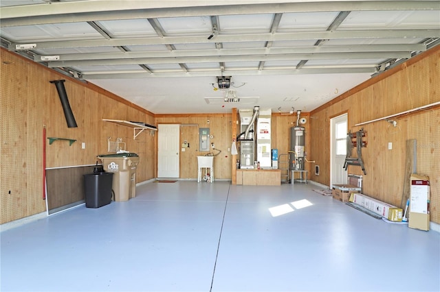 4848 Saint Andrews Arc, Leesburg, FL 34748 - garage with wood walls, a garage door opener, water heater, and a sink