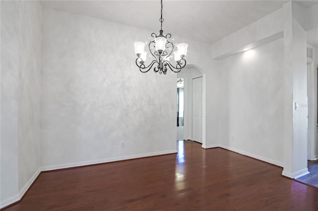 4848 Saint Andrews Arc, Leesburg, FL 34748 - unfurnished dining area featuring wood finished floors, baseboards, a notable chandelier, and arched walkways
