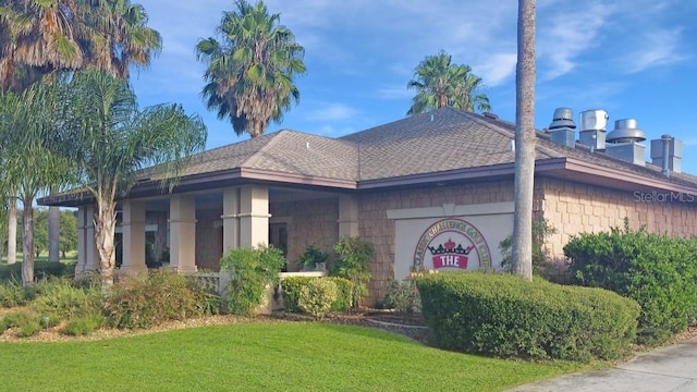 4848 Saint Andrews Arc, Leesburg, FL 34748 - view of property exterior featuring roof with shingles and a yard