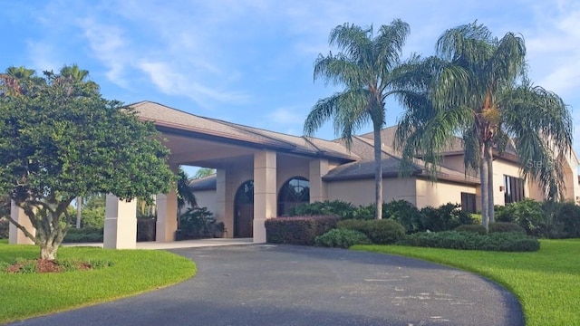 4848 Saint Andrews Arc, Leesburg, FL 34748 - exterior space featuring a front yard, driveway, and stucco siding