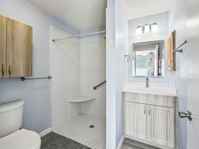 full bathroom with vanity, toilet, baseboards, walk in shower, and ceiling fan