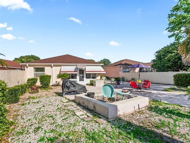back of house with fence, stucco siding, and a patio area