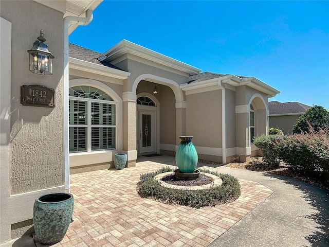 1842 Lake Ridge Dr, The Villages, FL 32162 - property entrance featuring roof with shingles and stucco siding