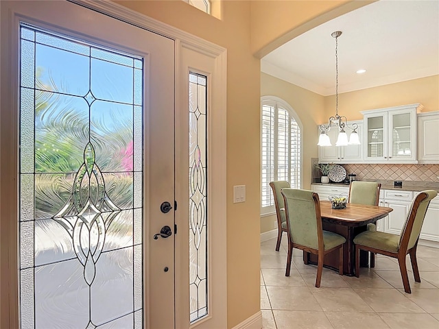 1842 Lake Ridge Dr, The Villages, FL 32162 - dining room featuring an inviting chandelier, arched walkways, baseboards, and light tile patterned floors