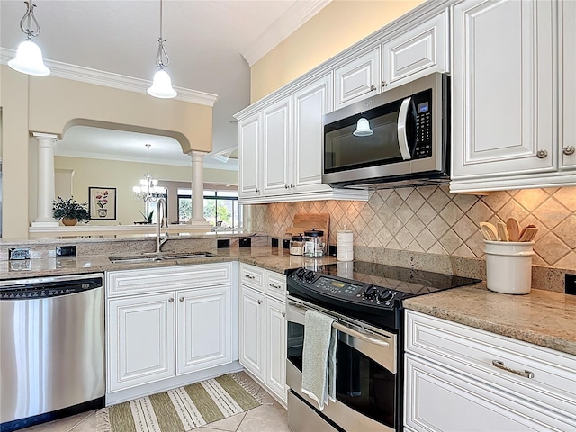 1842 Lake Ridge Dr, The Villages, FL 32162 - kitchen with a sink, appliances with stainless steel finishes, ornate columns, and white cabinetry
