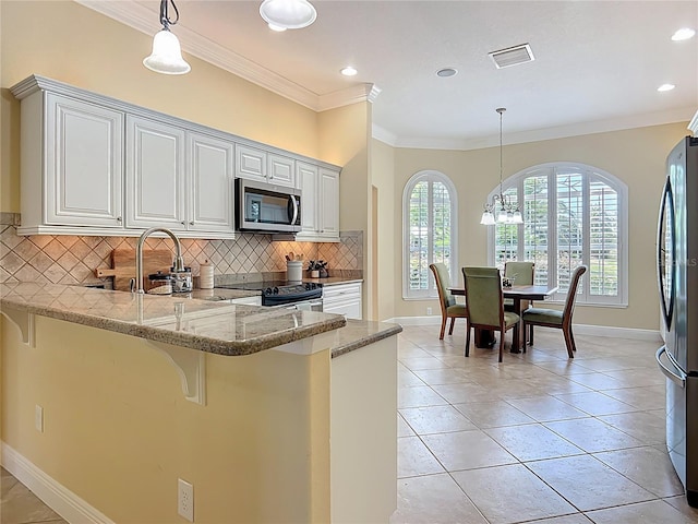 1842 Lake Ridge Dr, The Villages, FL 32162 - kitchen featuring appliances with stainless steel finishes, baseboards, light stone countertops, and backsplash