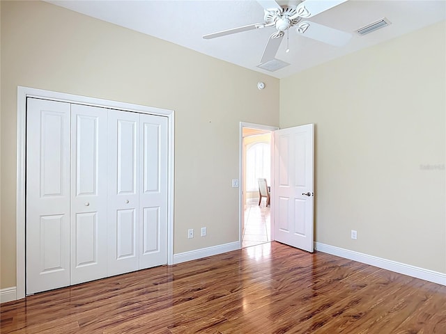 1842 Lake Ridge Dr, The Villages, FL 32162 - unfurnished bedroom featuring visible vents, baseboards, wood finished floors, and a closet