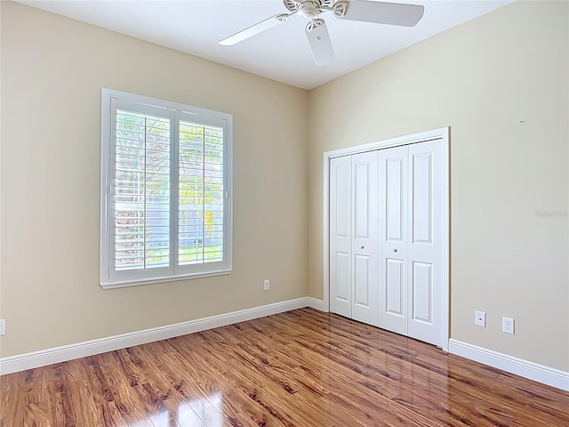 1842 Lake Ridge Dr, The Villages, FL 32162 - unfurnished bedroom with baseboards, wood finished floors, and a closet