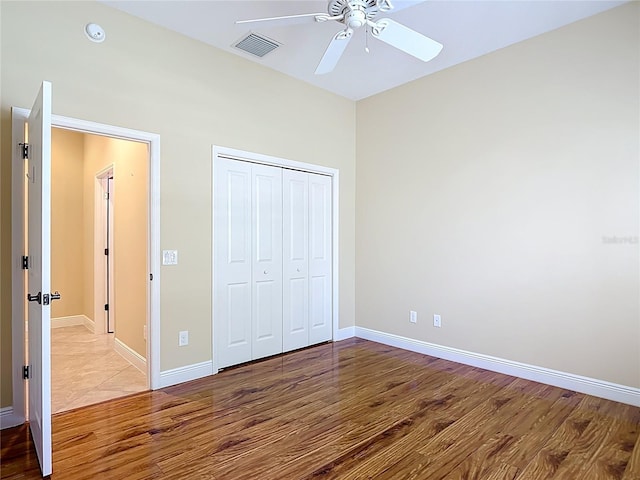 1842 Lake Ridge Dr, The Villages, FL 32162 - unfurnished bedroom with a ceiling fan, baseboards, wood finished floors, visible vents, and a closet