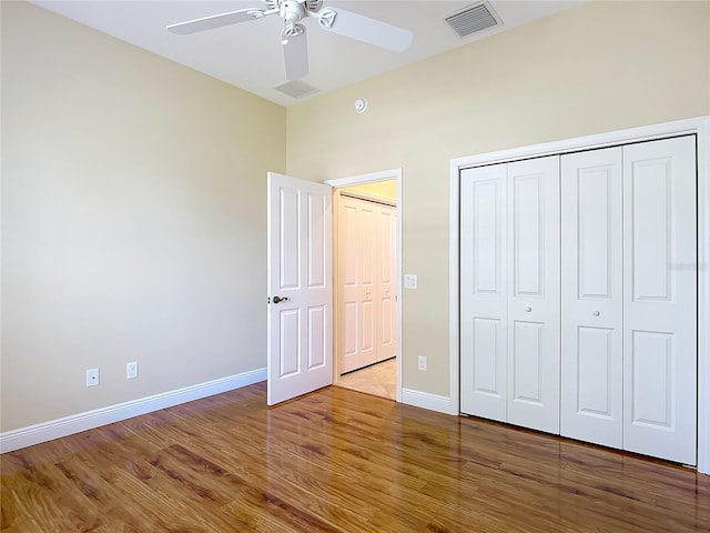 1842 Lake Ridge Dr, The Villages, FL 32162 - unfurnished bedroom featuring ceiling fan, baseboards, wood finished floors, visible vents, and a closet