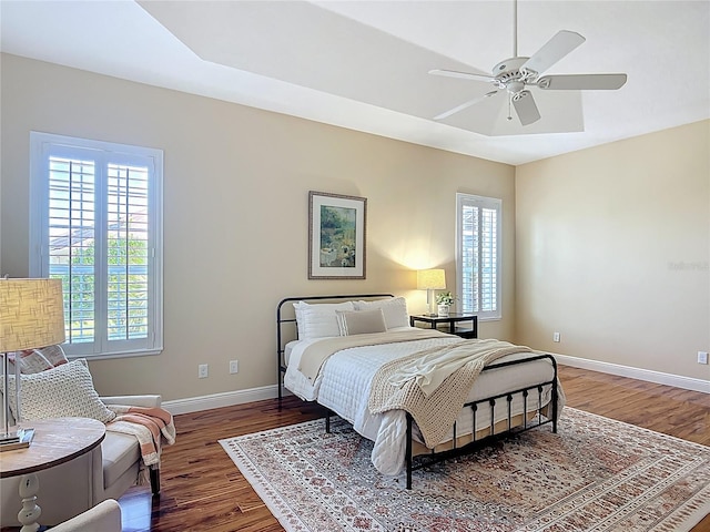 1842 Lake Ridge Dr, The Villages, FL 32162 - bedroom featuring baseboards, wood finished floors, and multiple windows