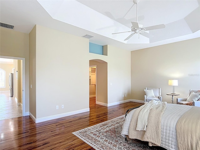 1842 Lake Ridge Dr, The Villages, FL 32162 - bedroom featuring visible vents, arched walkways, and wood finished floors
