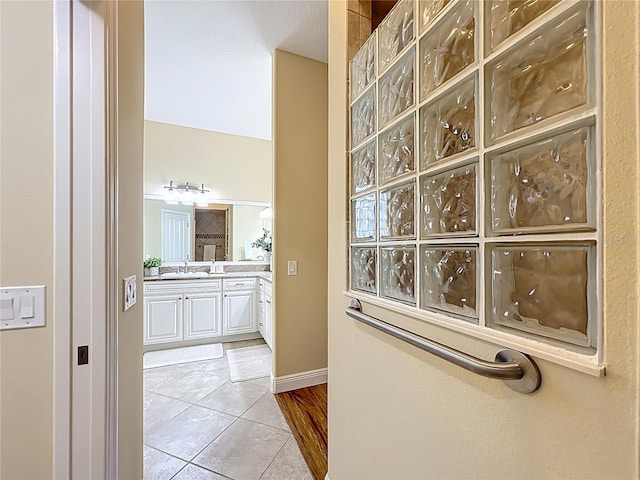 1842 Lake Ridge Dr, The Villages, FL 32162 - hallway with a sink, baseboards, and tile patterned flooring