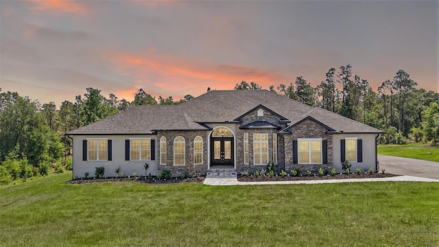 40050 Darlington Ave, Lady Lake, FL 32159 - french country home featuring a lawn, french doors, and stone siding