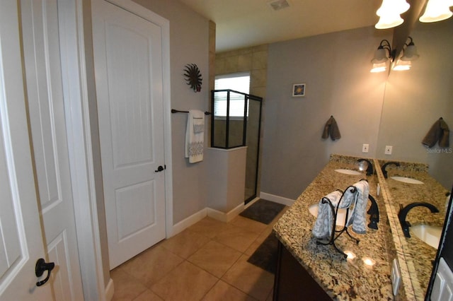 709 Calabria Way, Howey In The Hills, FL 34737 - full bath featuring a chandelier, a stall shower, double vanity, tile patterned flooring, and baseboards