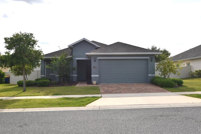 709 Calabria Way, Howey In The Hills, FL 34737 - ranch-style house with a front yard, an attached garage, stucco siding, decorative driveway, and a shingled roof