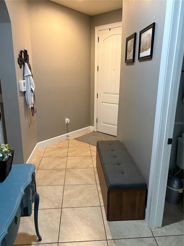 709 Calabria Way, Howey In The Hills, FL 34737 - corridor with tile patterned flooring, baseboards, and arched walkways