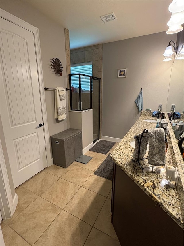 709 Calabria Way, Howey In The Hills, FL 34737 - bathroom featuring a stall shower, tile patterned floors, double vanity, and baseboards
