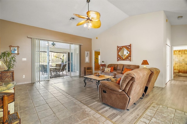 living room featuring baseboards, a ceiling fan, light wood-type flooring, and visible vents