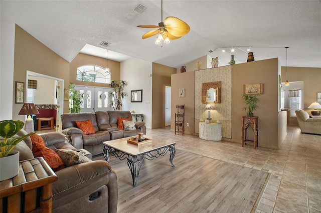 living room featuring visible vents, ceiling fan, and high vaulted ceiling