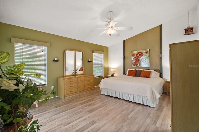 bedroom with baseboards, light wood-style flooring, and ceiling fan