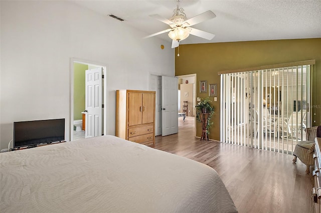 bedroom featuring visible vents, wood finished floors, access to exterior, high vaulted ceiling, and a ceiling fan