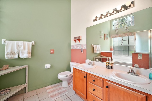 full bath with double vanity, a sink, a bath, and tile patterned floors