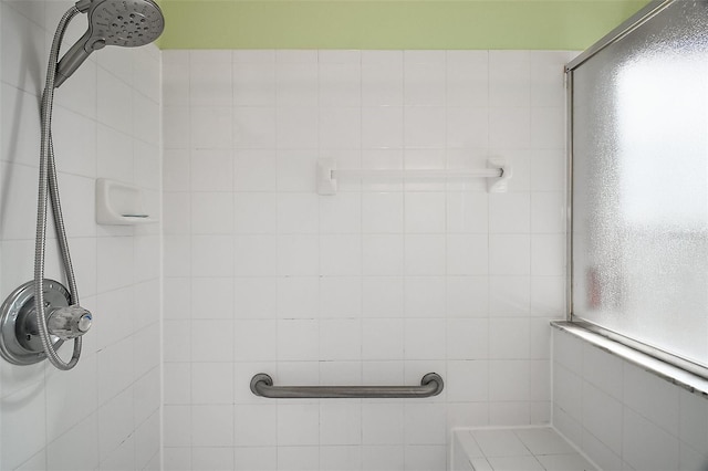 bathroom with a tile shower