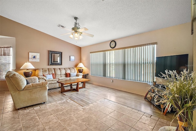 living room with a ceiling fan, a textured ceiling, visible vents, vaulted ceiling, and light wood-style floors