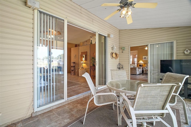 sunroom / solarium with ceiling fan and outdoor dining space