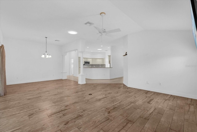 unfurnished living room featuring visible vents, baseboards, light wood finished floors, and ceiling fan with notable chandelier