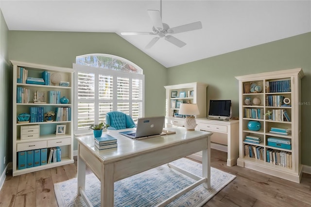 office area with a ceiling fan, lofted ceiling, and light wood-type flooring