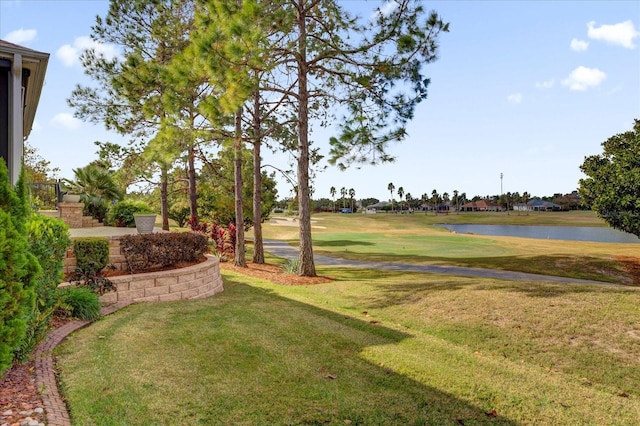 view of yard featuring view of golf course and a water view