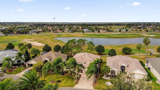 drone / aerial view with a residential view, a water view, and view of golf course