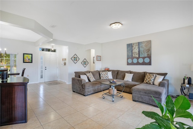 2641 Meadow View Ct, Kissimmee, FL 34746 - living area featuring light tile patterned floors, a chandelier, and arched walkways