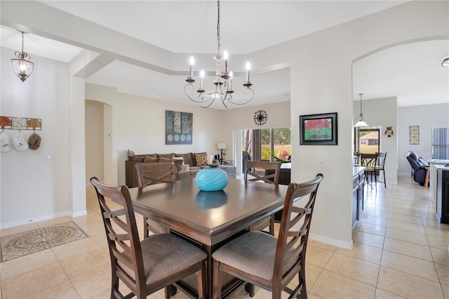 2641 Meadow View Ct, Kissimmee, FL 34746 - dining area featuring arched walkways, light tile patterned floors, and a chandelier