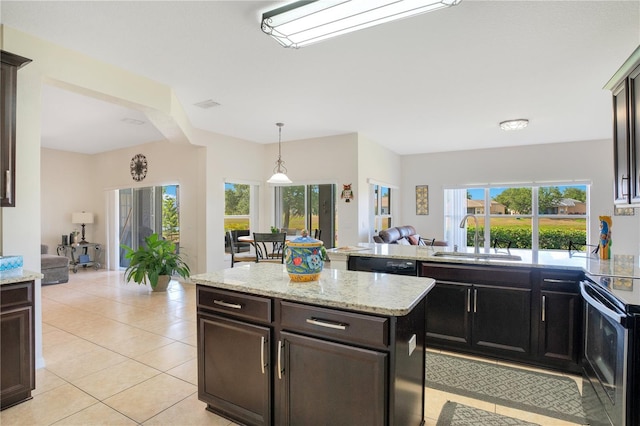 2641 Meadow View Ct, Kissimmee, FL 34746 - kitchen with range with electric cooktop, dishwasher, light tile patterned floors, a peninsula, and light stone counters